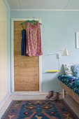 Vintage-style dresses hung from door in bedroom