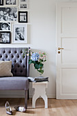 Vase of flowers on stool next to sofa