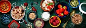 Healthy breakfast of muesli, berries with yogurt and seeds on dark background