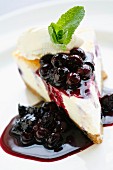 A piece of cheesecake with blackcurrants