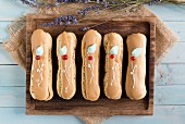 Chocolate eclairs on a wooden board