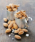 Roasted salted almonds on wooden background