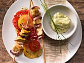 Chicken skewers and tomato salad with avocado and yoghurt cream