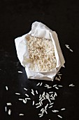Basmati rice in a paper bag on a black background