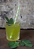 Fig leaves in a glass with a straw