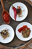 Three spice mixes and a spoon of barbecue sauce