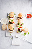 mini burgers with ketchup and sour cream