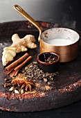 Ingredients for Indian masala tea on dark background