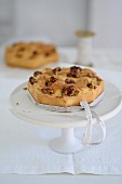 Apple nut cake with a bow on a cake stand