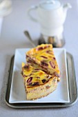 Two pieces of plum tart on a plate