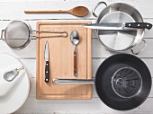 Various kitchen utensils: pot, pan, salad spinner, sieve
