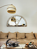 Mirrors in fanlight frame on wall above sofa