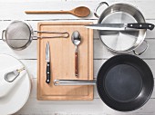 Various kitchen utensils: pot, pan, strainer, salad spinner