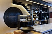 Partition shelving in front of steel staircase in designer kitchen