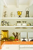 Orange, tiled kitchen worksurface in white kitchen