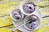 Several bowls of blueberry ice cream on a plate