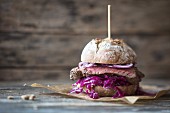 A steak burger with red cabbage