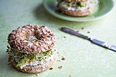 Whole wheat bagels with avocado, sprouts and cream cheese