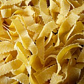 Close up of pasta nests of egg pappardelle, reginette cut