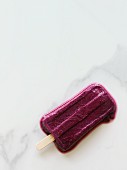 Blueberry ice cream pop, partially melted