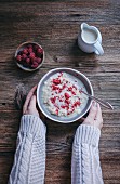 Woman eating millet porridge with raspberry powder