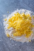 A heap of flour with grated butter