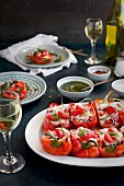 Black Rice Caprese Stuffed Roasted Red Peppers served with a fresh Basil Oil and white wine