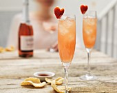 Champagne cocktails with hibiscus and strawberry hearts