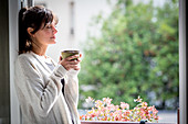 Woman drinking hot beverage