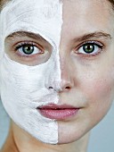 Portrait of a woman with a face mask on half of her face