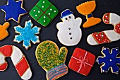 Colourful decorated Christmas cookies on a dark background