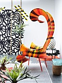 Artistically curved outdoor easy chair with ethnic striped pattern