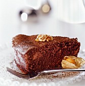 A piece of chocolate cake with nuts, honey and physalis