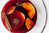 Mulled red wine with spices and fruit in a glass