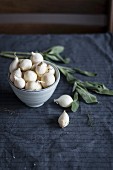 Small white onions in ceramic bowl