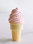Cone of soft strawberry ice cream