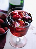 Sangria with red berries and ice cubes