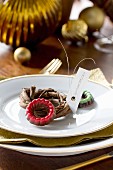 Small chocolate rings and mini wreath used as name tag on plate