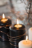 Black candles wrapped in copper wire