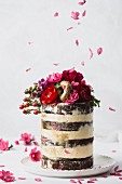 Wedding cake with buttercream, flowers, and gold donuts