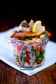 Lunch in a glass jar: chickpea salad and crostini with smoked cod liver, pesto and lemon