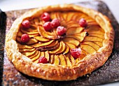 A whole french apple tart on a baking tray