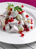 A plate of chicken fruit salad
