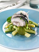 Rolled pickled mackerel on a bed of cucumber sticks