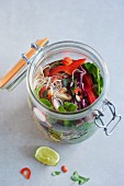 Vegan noodles with shiitake mushrooms and spinach in a glass jar (Asia)