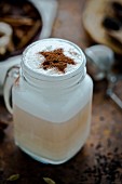 A chai latte decorated with a cocoa powder star