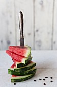 Triangle-shaped pieces of watermelon with a knife stuck through them