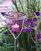 Decorative garden stakes with glass tealight holders on top