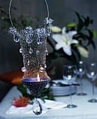 Ornate, suspended, wire-mesh candle holder decorated with crystals