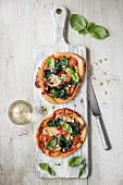 Mini goats cheese and spinach pizza with pine nuts, view from above